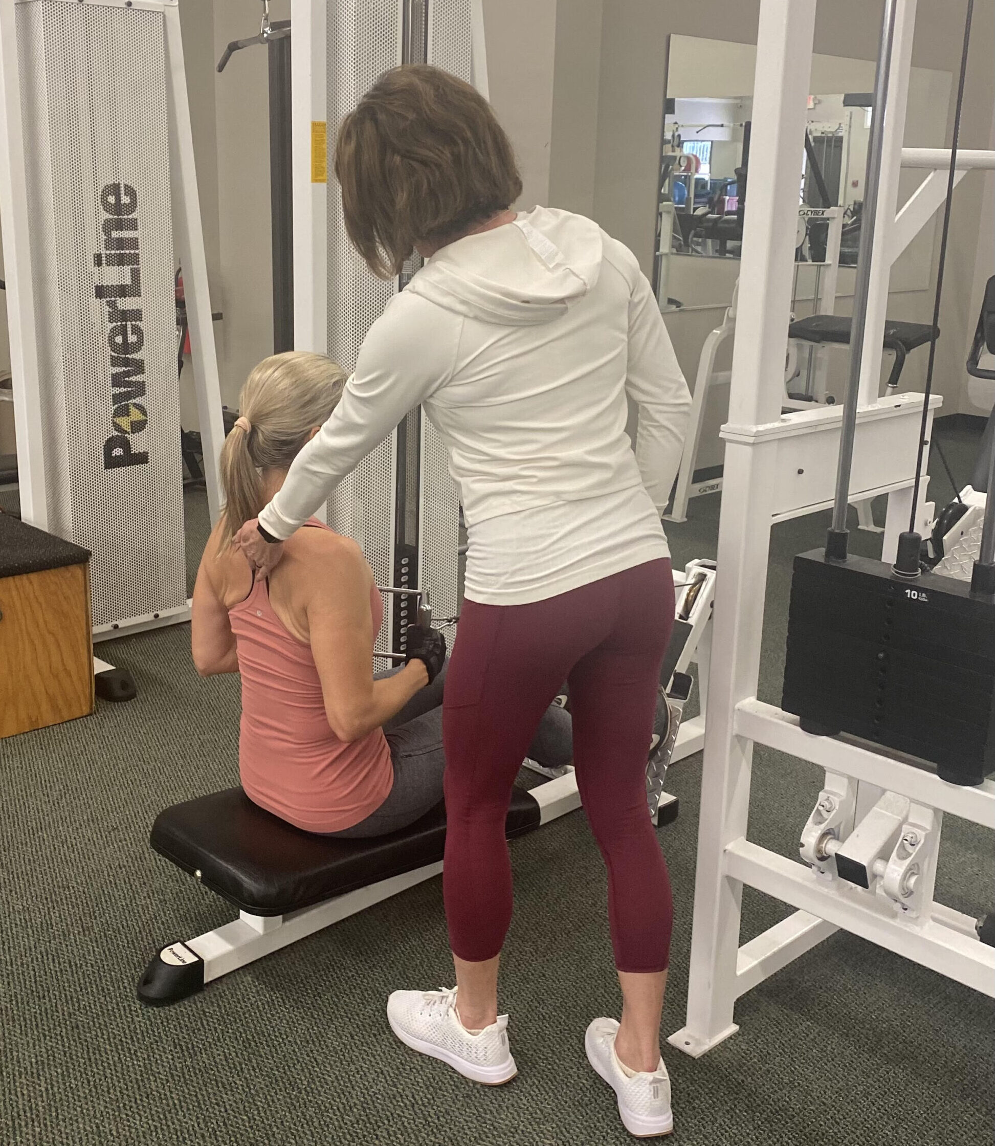 helping a client with weight machine
